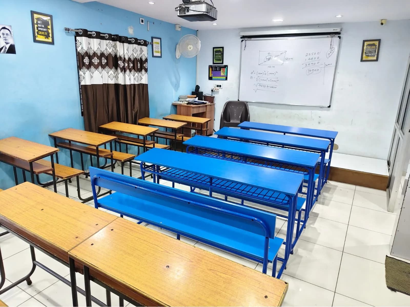 A bright Ronak Coaching Center classroom with whiteboard and royal-blue benches