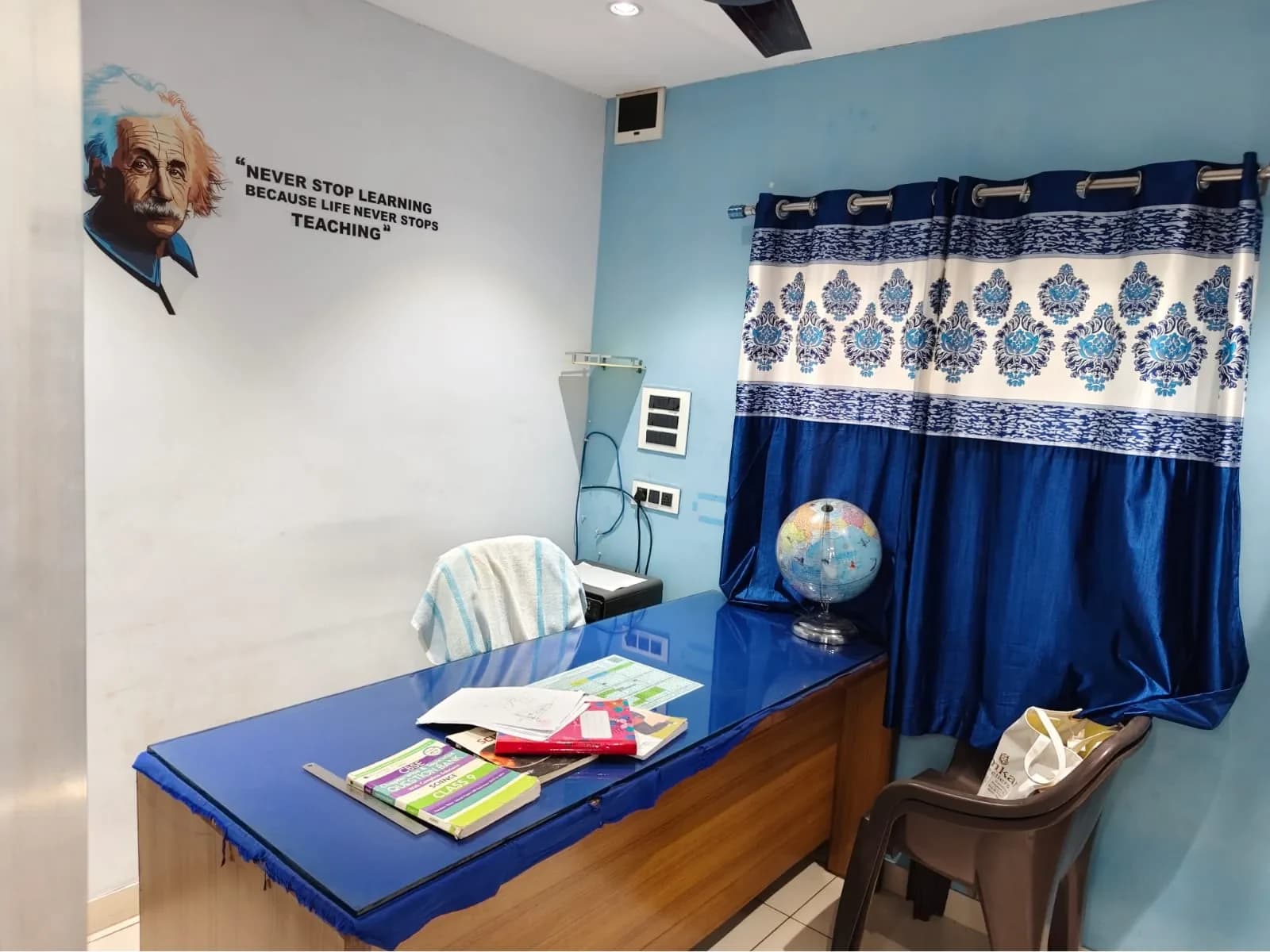 Office wall carrying the Ronak Coaching Center motto